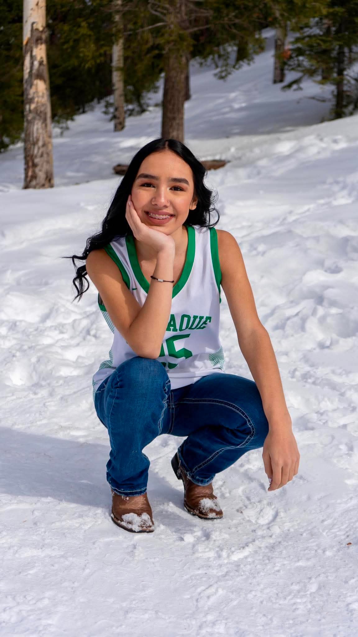 Senior portrait in a team jersey, snow, mountains