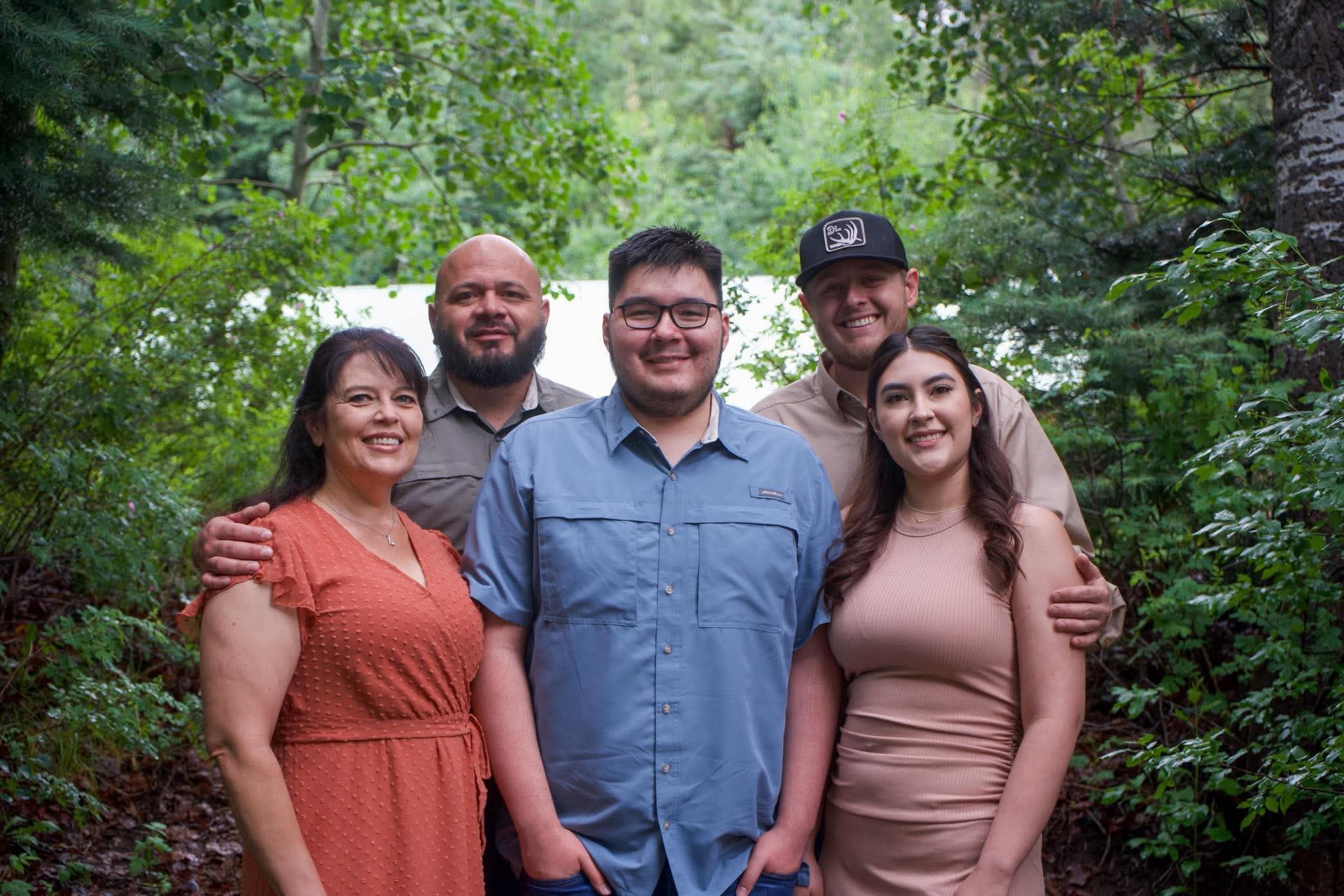 A family portrait in a forest clearing