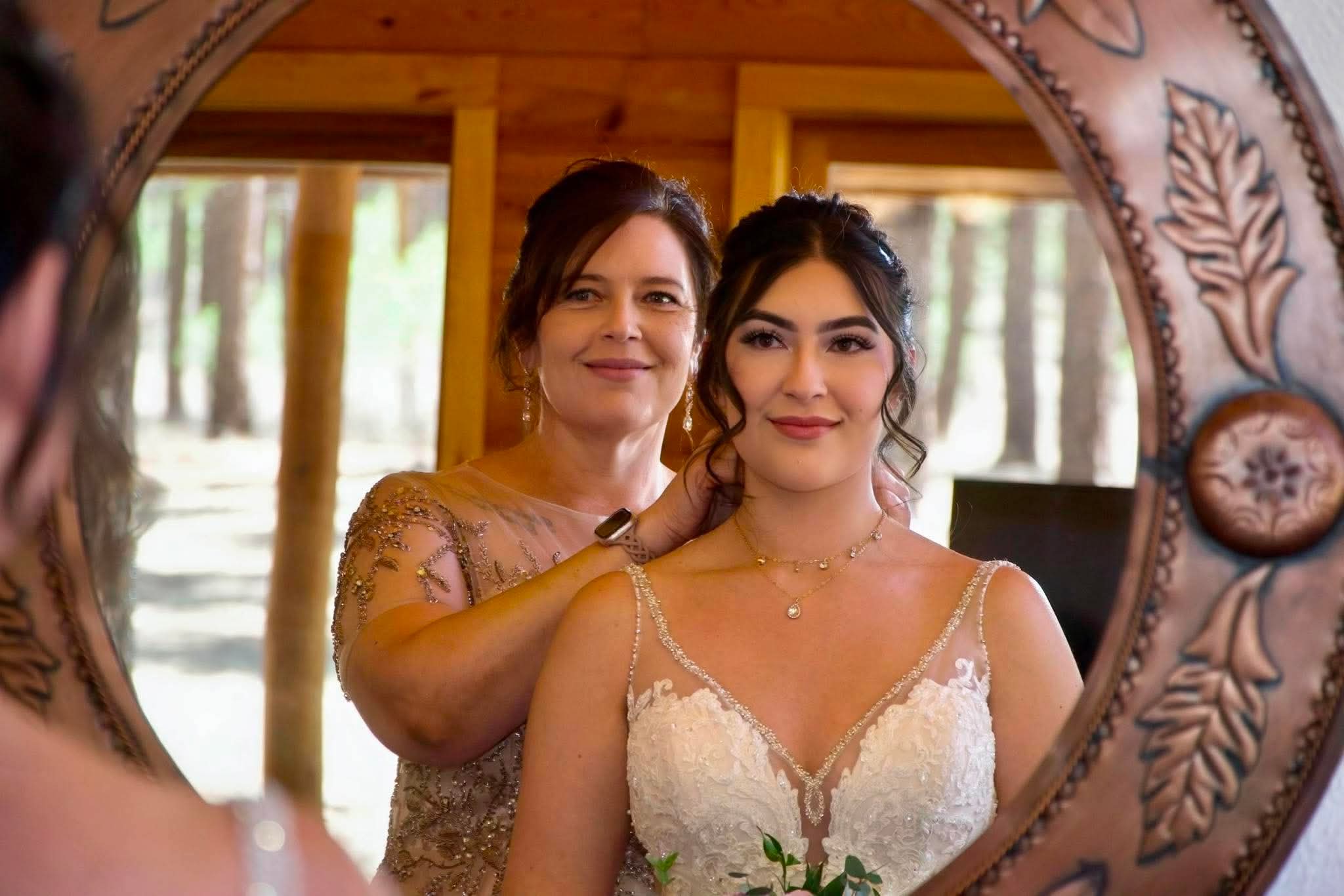 Bride having her hair finished by her mother before the ceremony