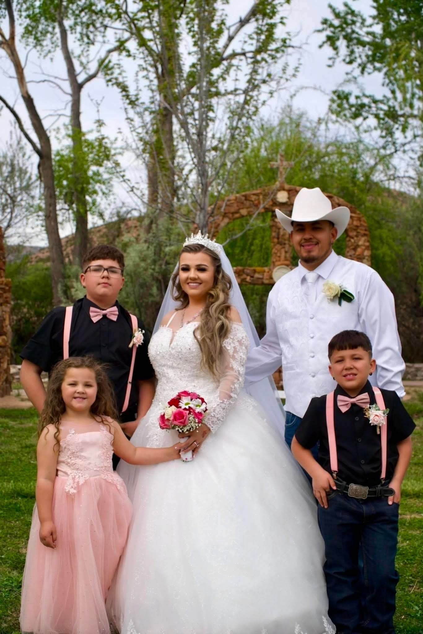 Bride and groom with three young family members